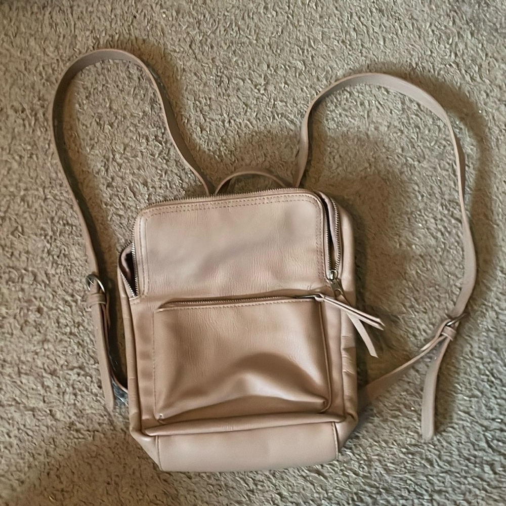 Mini backpack. Very stylish and auburn maroon gray color. Used for travel 🧳